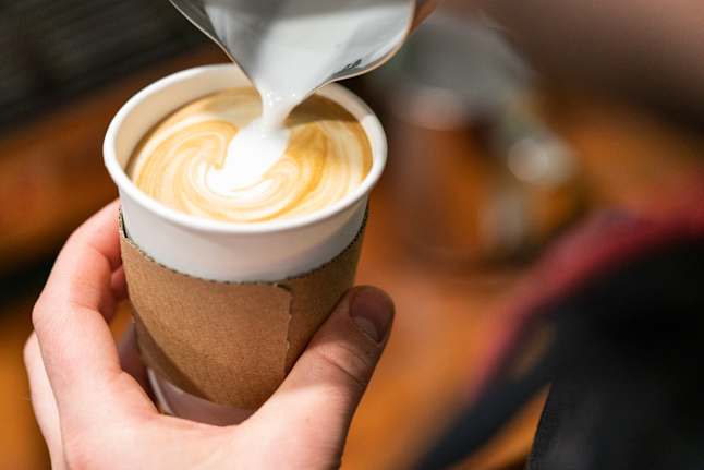 A cup of coffee being poured for a Dining Deals customer