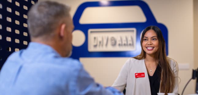 AAA representative helping member inside AAA branch
