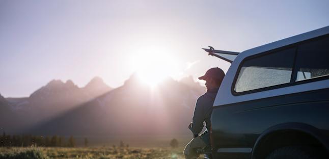 Man sitting in back of truck