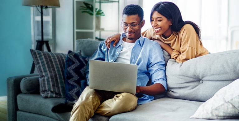 a couple with AAA insurance check their laptop at home