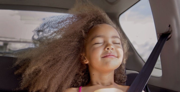 Girl in a car protected by aaa auto insurance