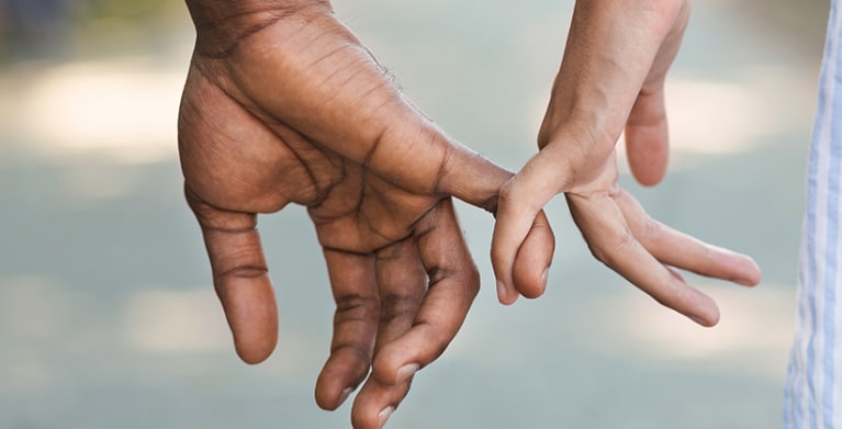 Couple holding hands as they walk to a AAA branch.  