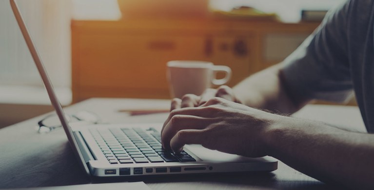 a man completes a AAA reimbursement form on his laptop