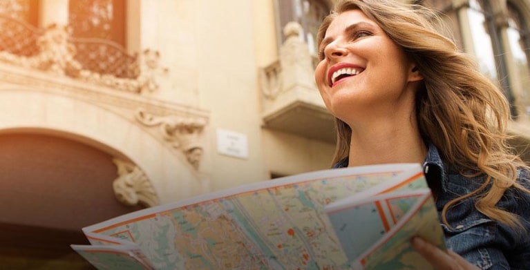 Woman using a map she received from AAA