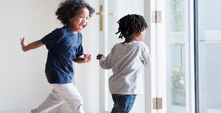 Two young sisters run through their new condo home insured by AAA.