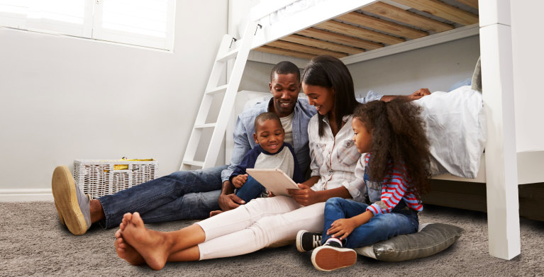 Family with AAA Plus looking at a laptop