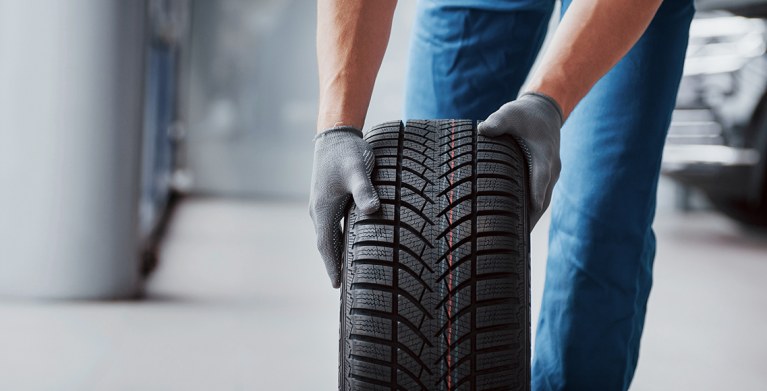 AAA Approved Auto Repair Shop replaces a tire on a Member's vehicle