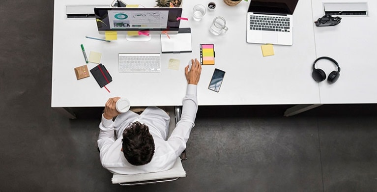 a small business owner with AAA business insurance works at his desk