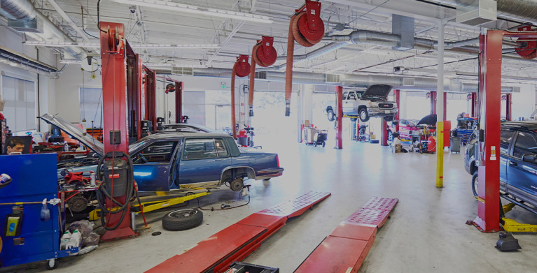 a red car getting maintenance in a AAA auto repair shop