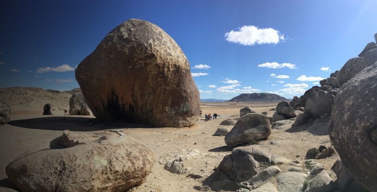 Giant Rock in front of a cloudy blue desert sky in Landers, CA