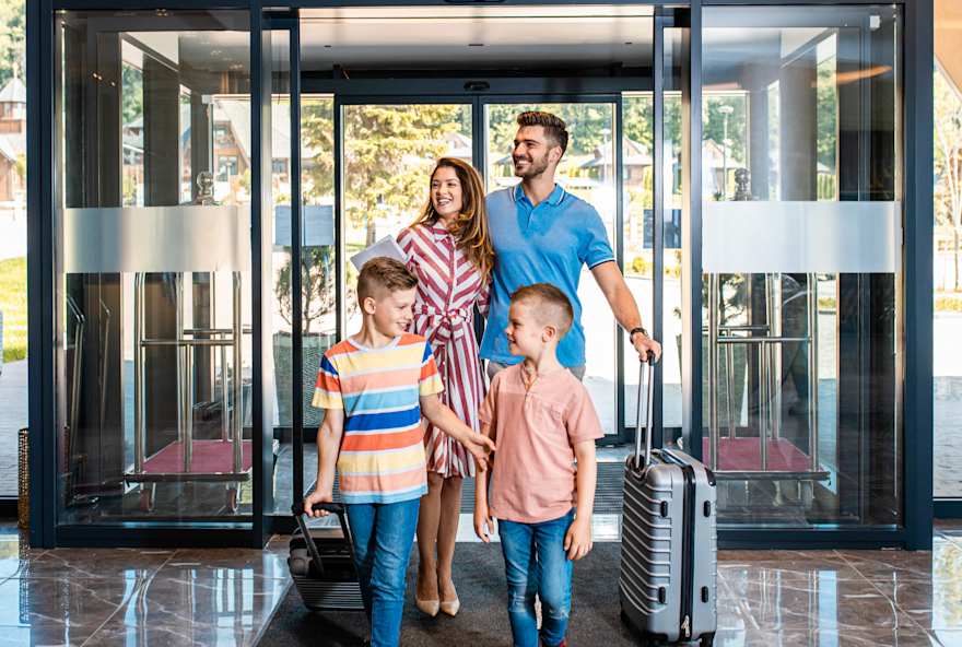 A family enters a hotel lobby