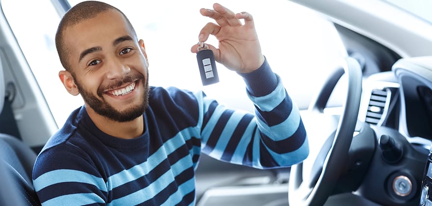 first time car buyer holds keys to their new car