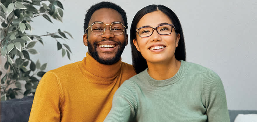 two AAA members smile with LensCrafters glasses on