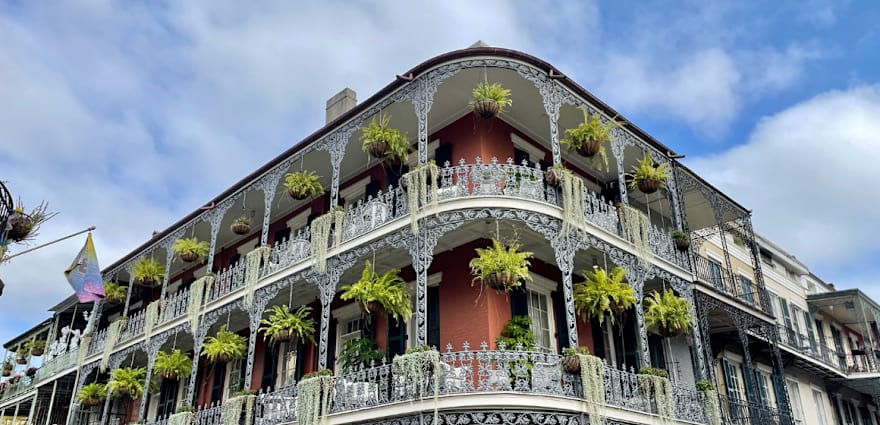 ornate balcony with greenery hanging