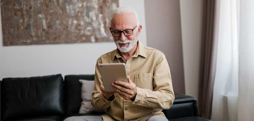 a person looks at the tablet as they review their retirement savings