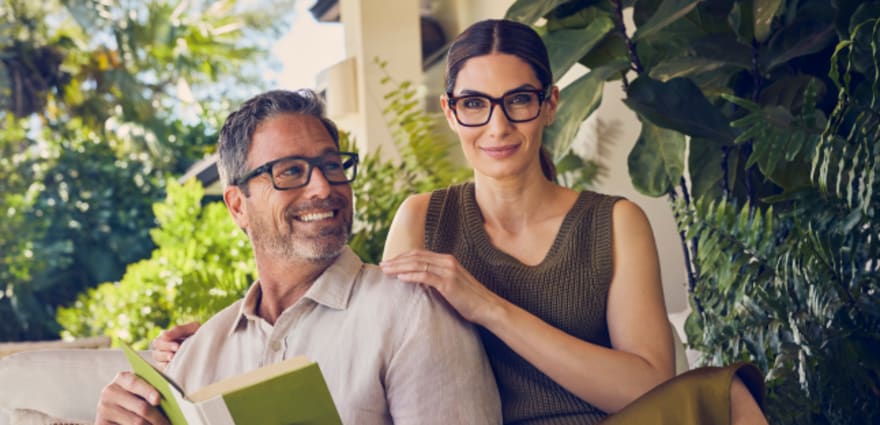 two AAA members smile with LensCrafters glasses on