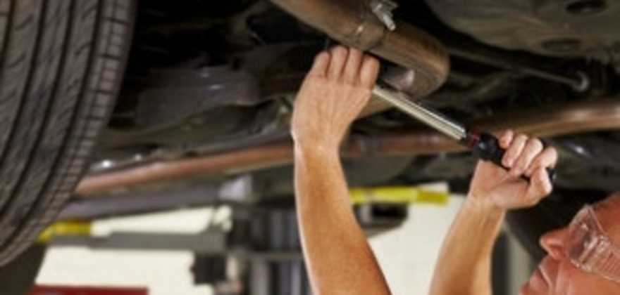 A AAA car mechanic repairs an auto in the shop