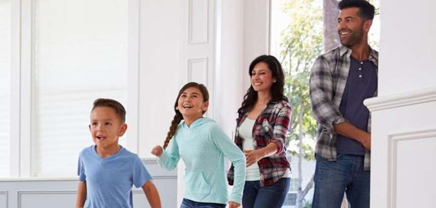 Happy family of AAA members enter their new home