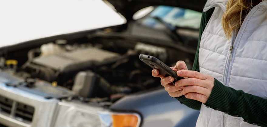 a woman requests AAA roadside service from the AAA mobile app
