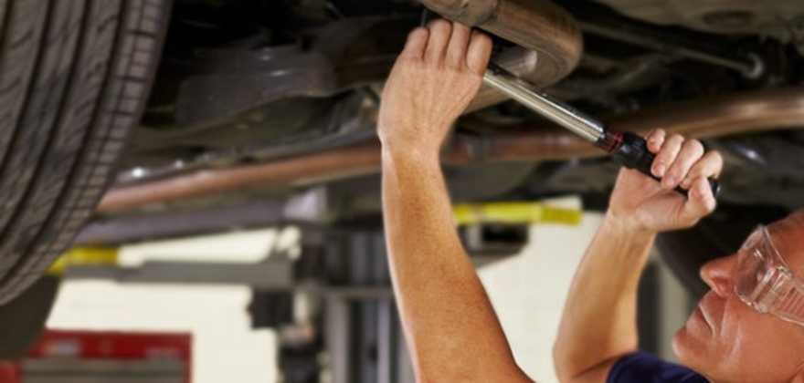 A AAA car mechanic repairs an auto in the shop