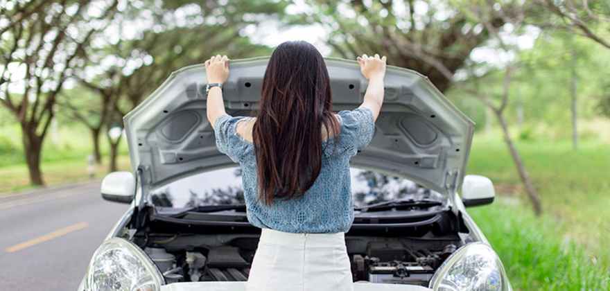 A AAA Member looks at a car battery