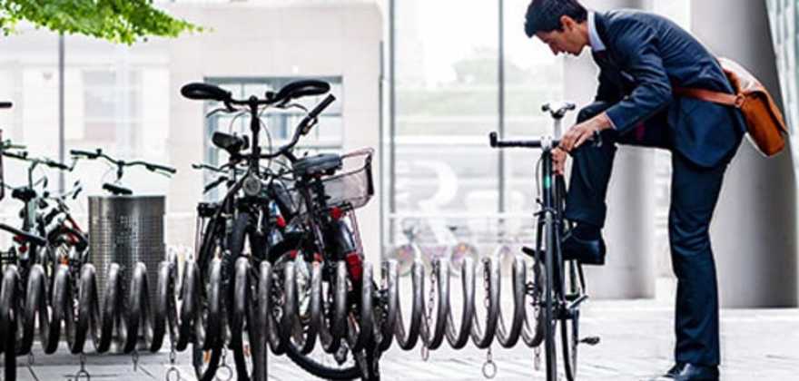 A AAA member locks their bicycle outside an office