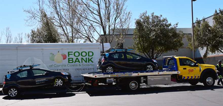 a AAA tow truck drops off a GIG Car Share vehicle