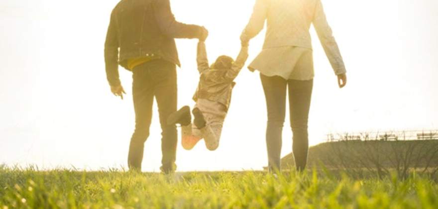 Couple playing with their small child in a park