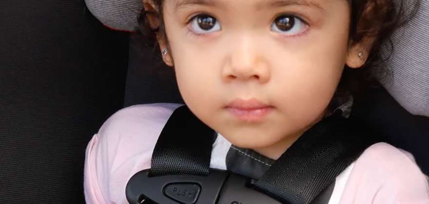 a child sits during a AAA car seat inspection