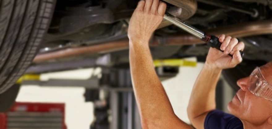 auto mechanic works on a car