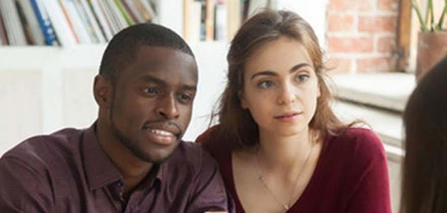 Couple discussing AAA renters insurance with an agent