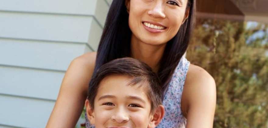 Mother and son sitting in front of house covered by AAA renters insurance