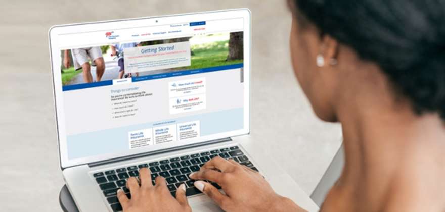 Woman researching aaa life insurance policies on her laptop