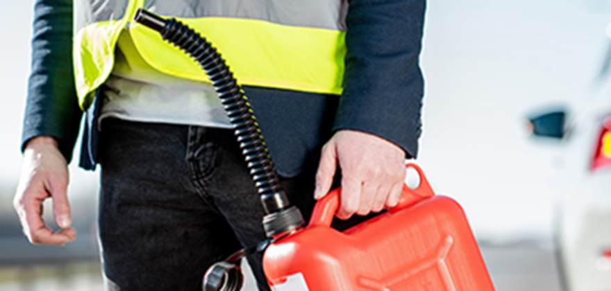 a AAA employee delivers gas to a stranded driver