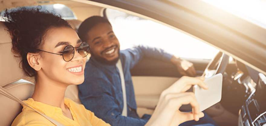 a couple with aaa car insurance takes a selfie on their road trip