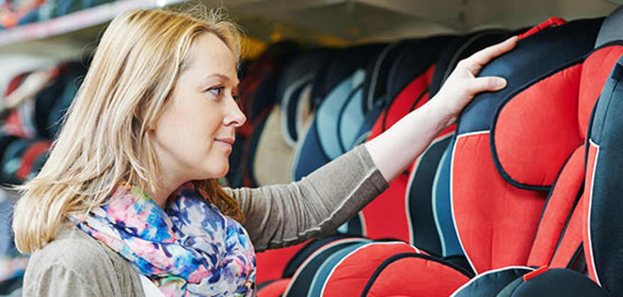 an expecting mother shops for a car seat