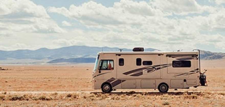 Motorhome RV covered by AAA Insurance driving across the desert