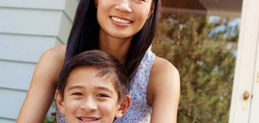 a mom sits on the stoop of her rental home insured by AAA insurance