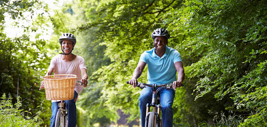 Couple riding bikes on a wooded path