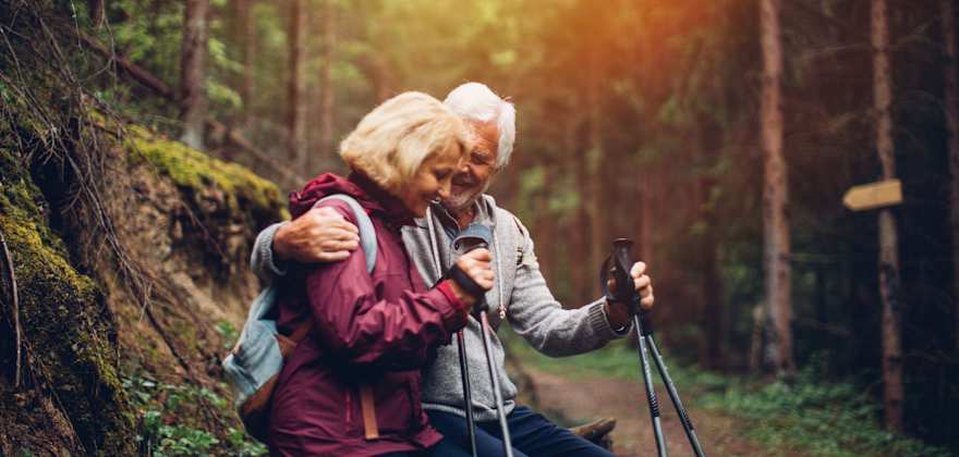 an older couple insured by AAA life insurance on a hike