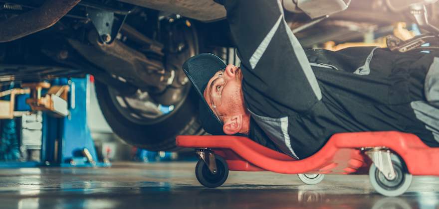 Mechanic servicing vehicle 