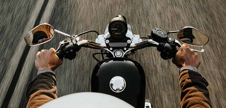 an overhead shot of a motorcycle rider holding onto the handlebars