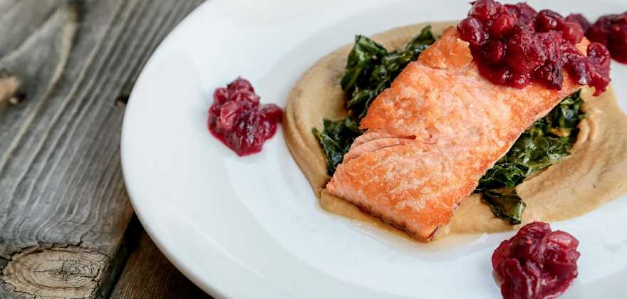 plate of pan-roasted salmon with cranberry compote, wilted greens on squash puree at Indian Pueblo Kitchen in the Pueblo Cultural Center, Albuquerque, New Mexico