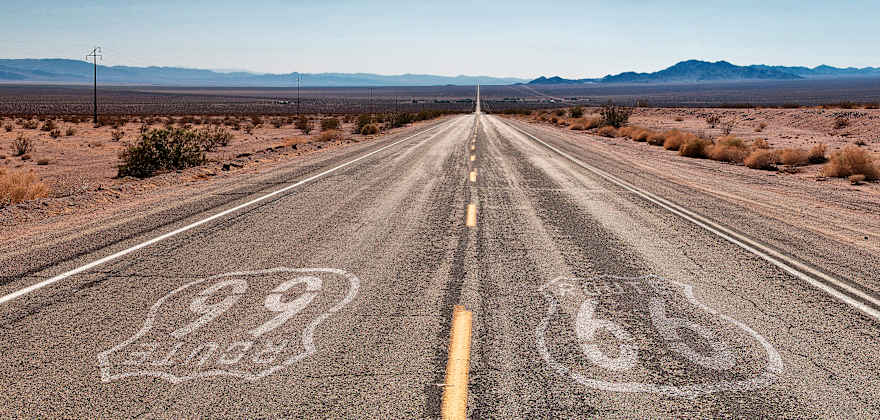 A desert highway marked with Route 66 symbols.