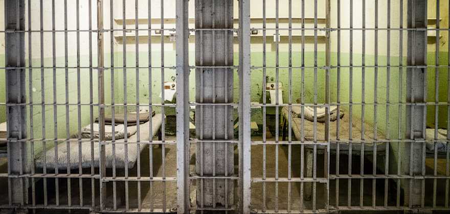 Beds sit in two prison cells on Alcatraz. 