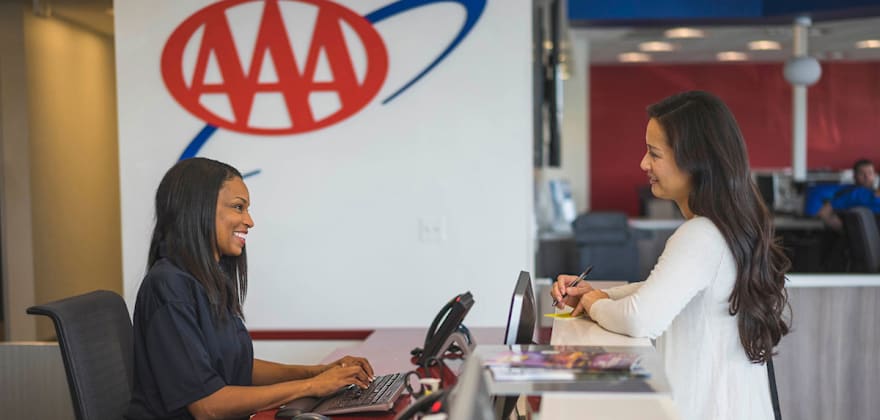 AAA insurance agent helps someone at a local branch
