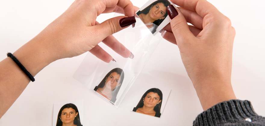 Passport photos being inserted into a sleeve
