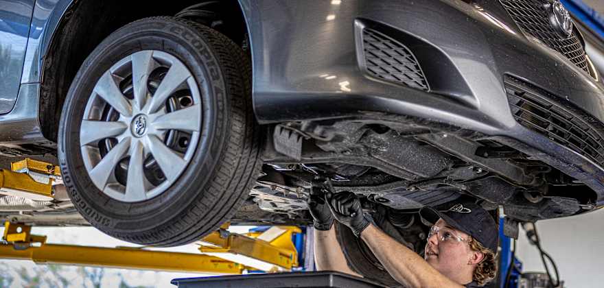 Technician performing an oil change service