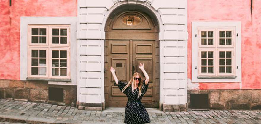 Happy woman walking in Stockholm