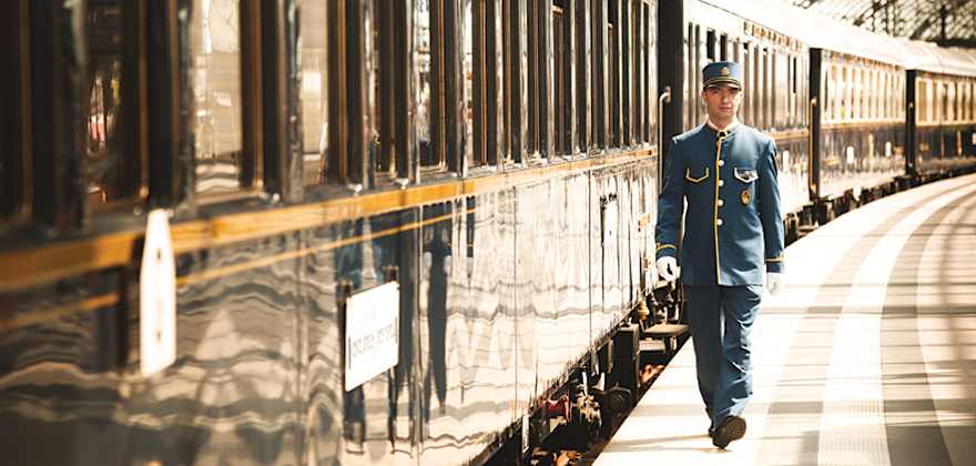 man walking next to venice simplon orient express train